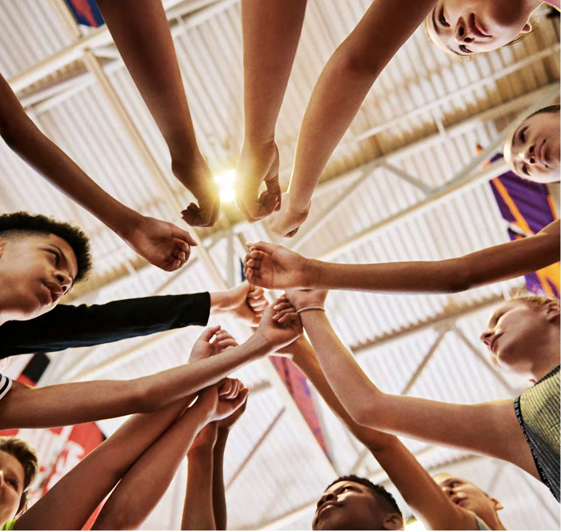 Team hands in for a huddle