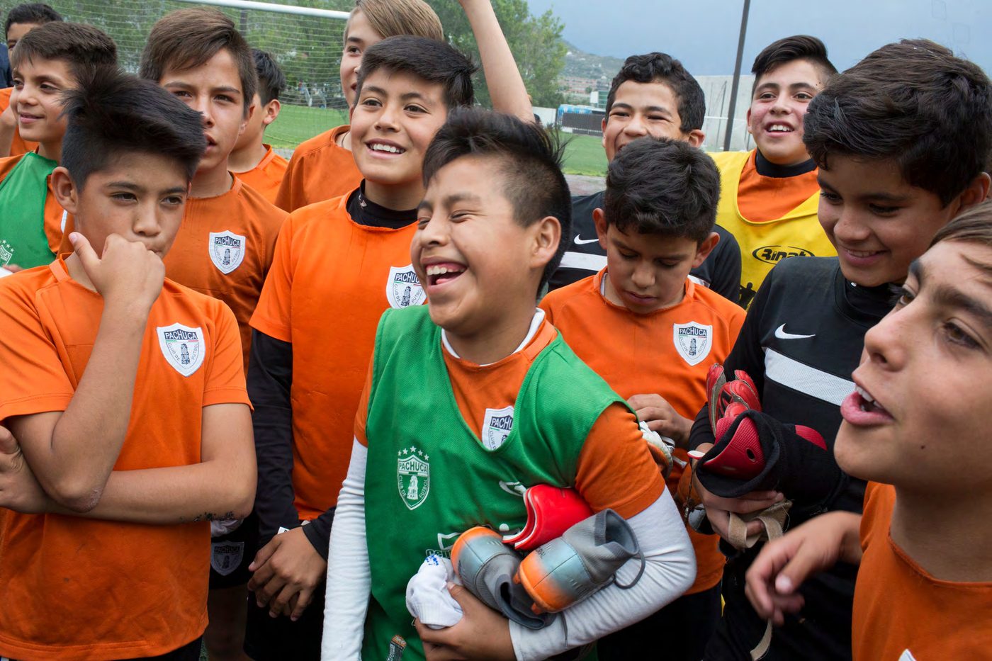 Young players laughing together on the sideline